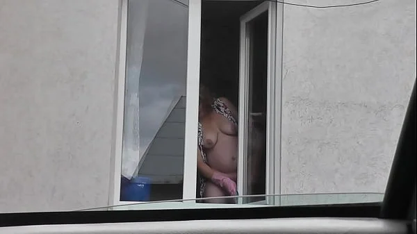 Sexy MILF Frina in dressing gown without panties and bra washes windows of apartment and is not shy about random taxi driver on street who looks out from his car. Naked in public. Nude in public. Public nudity. Publicly. Public. Natural tits Milf.