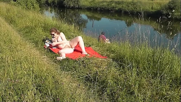 MILF sexy Frina on river bank undressed and sunbathes naked. Random man fisherman watching for her, and in the end decided to join naked woman. Wild beach. Nudist beach. Public nudity. Public exposure. Naked in public